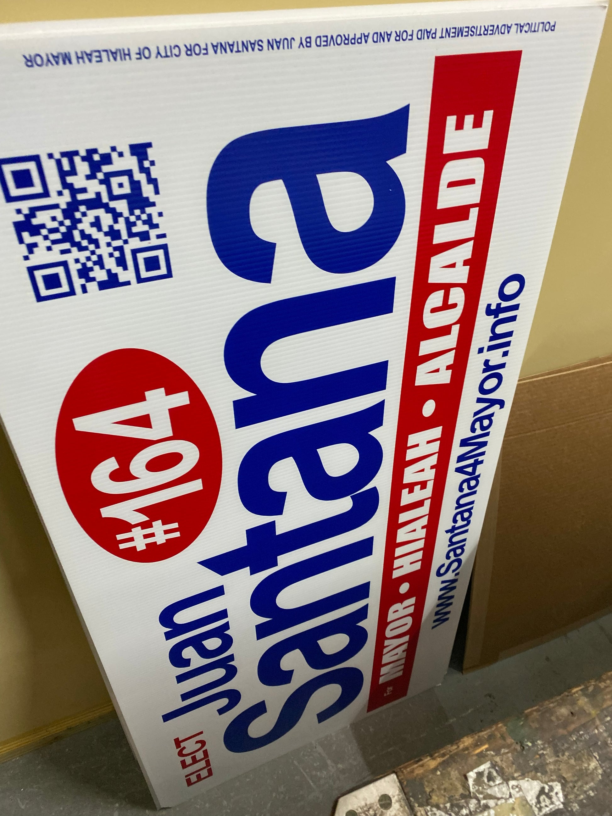 Political campaign sign for Juan Santana with a QR code and text.