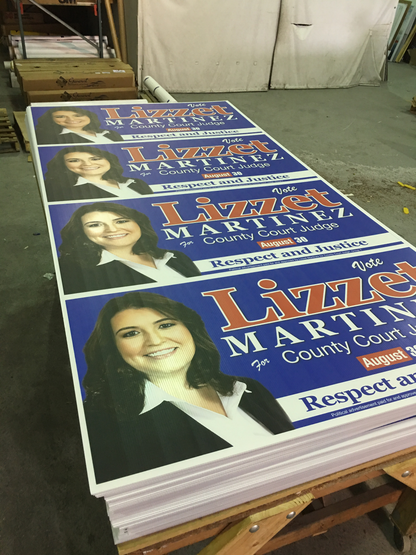 Stack of political campaign posters for a candidate named Lizzet Martin on a wooden table.