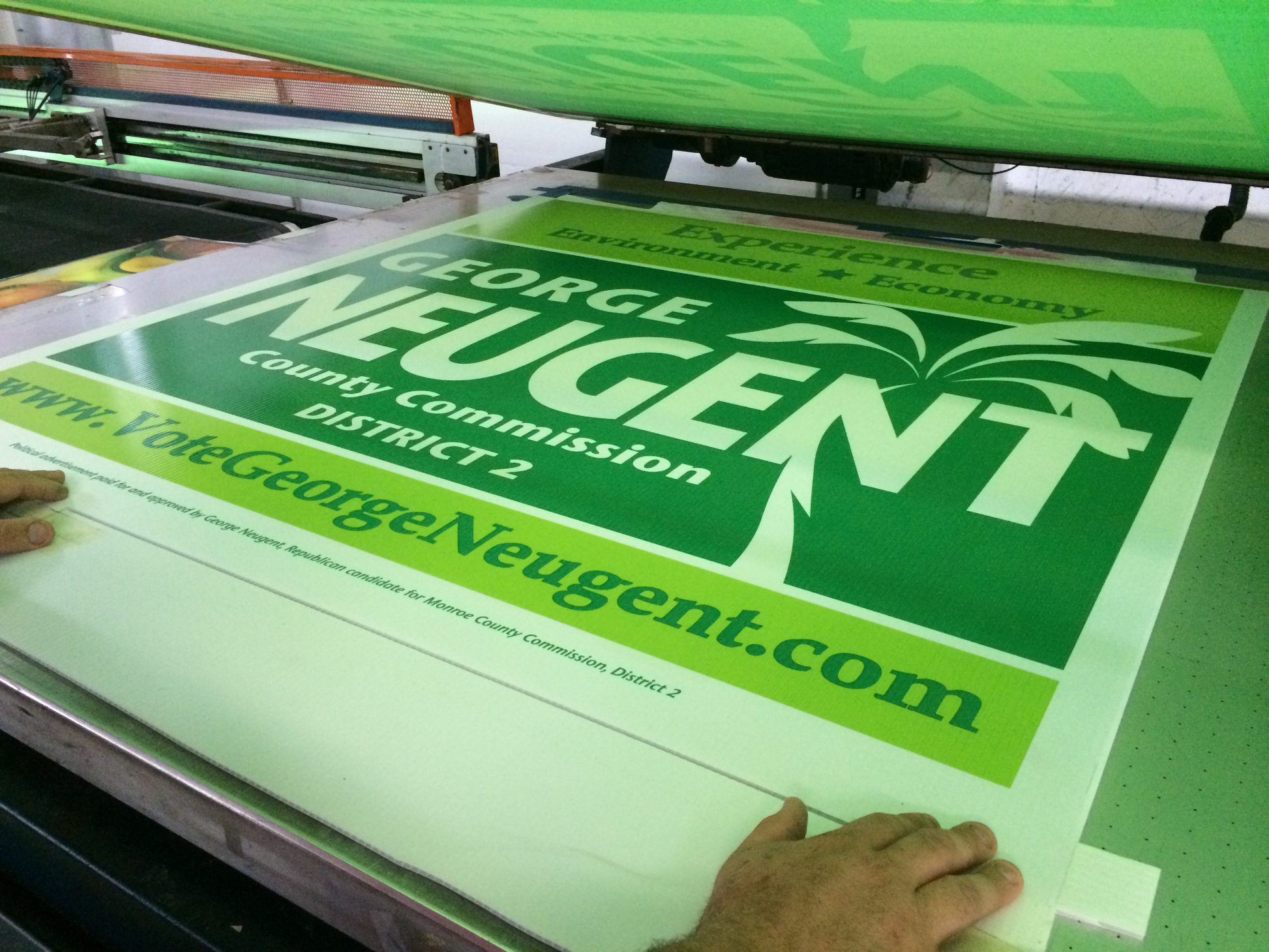 Green campaign sign for George Neugent being printed