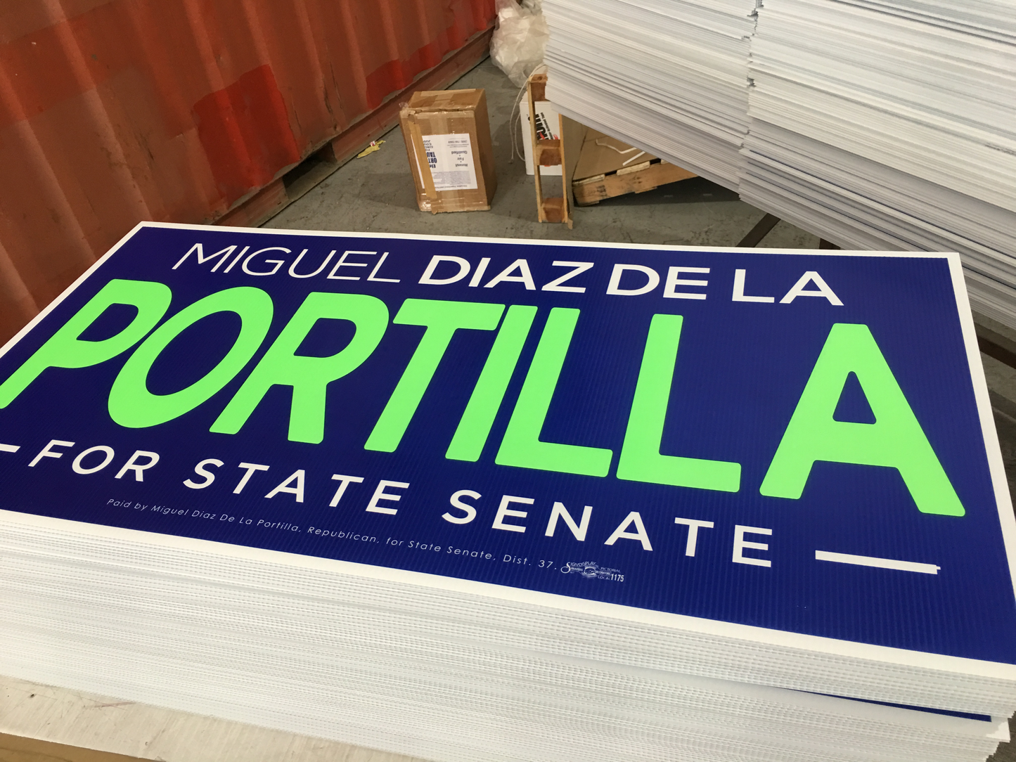 Miguel Diaz de la Portilla campaign sign with blue background and green text.