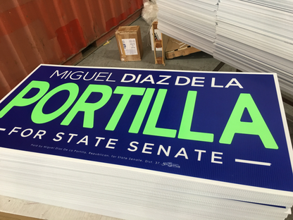 Miguel Diaz de la Portilla campaign sign with blue background and green text.